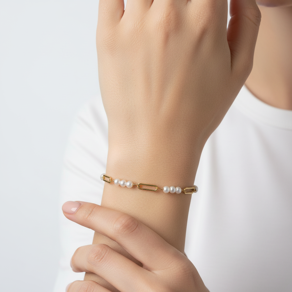 Gold Pearl Paperclip Chain Bracelet on elegant woman's wrist